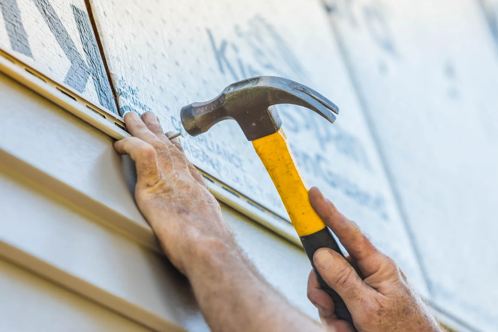 Craftsperson using a hammer during an installation